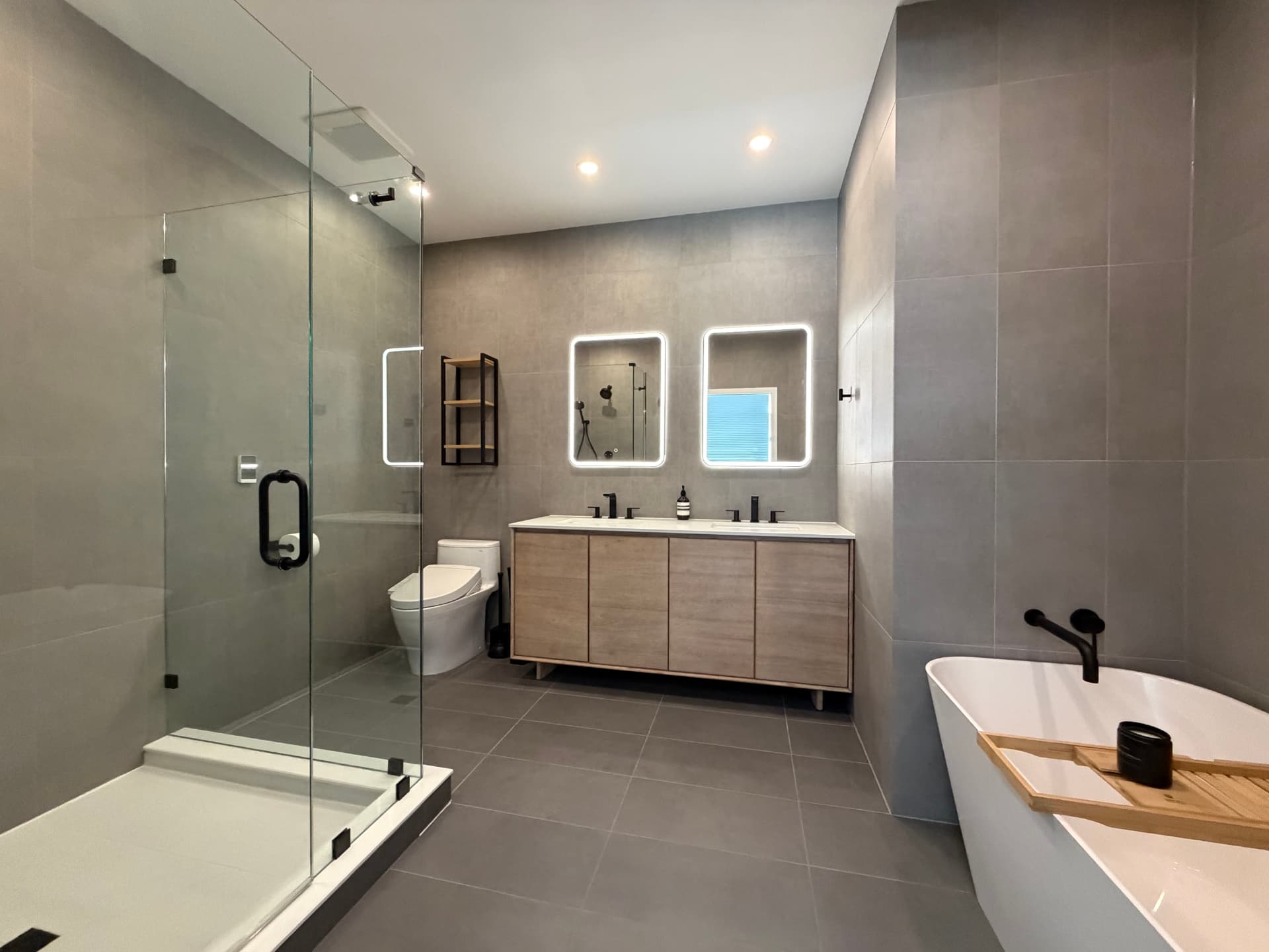 Wide view of the remodeled bathroom with tub, vanity, and shower