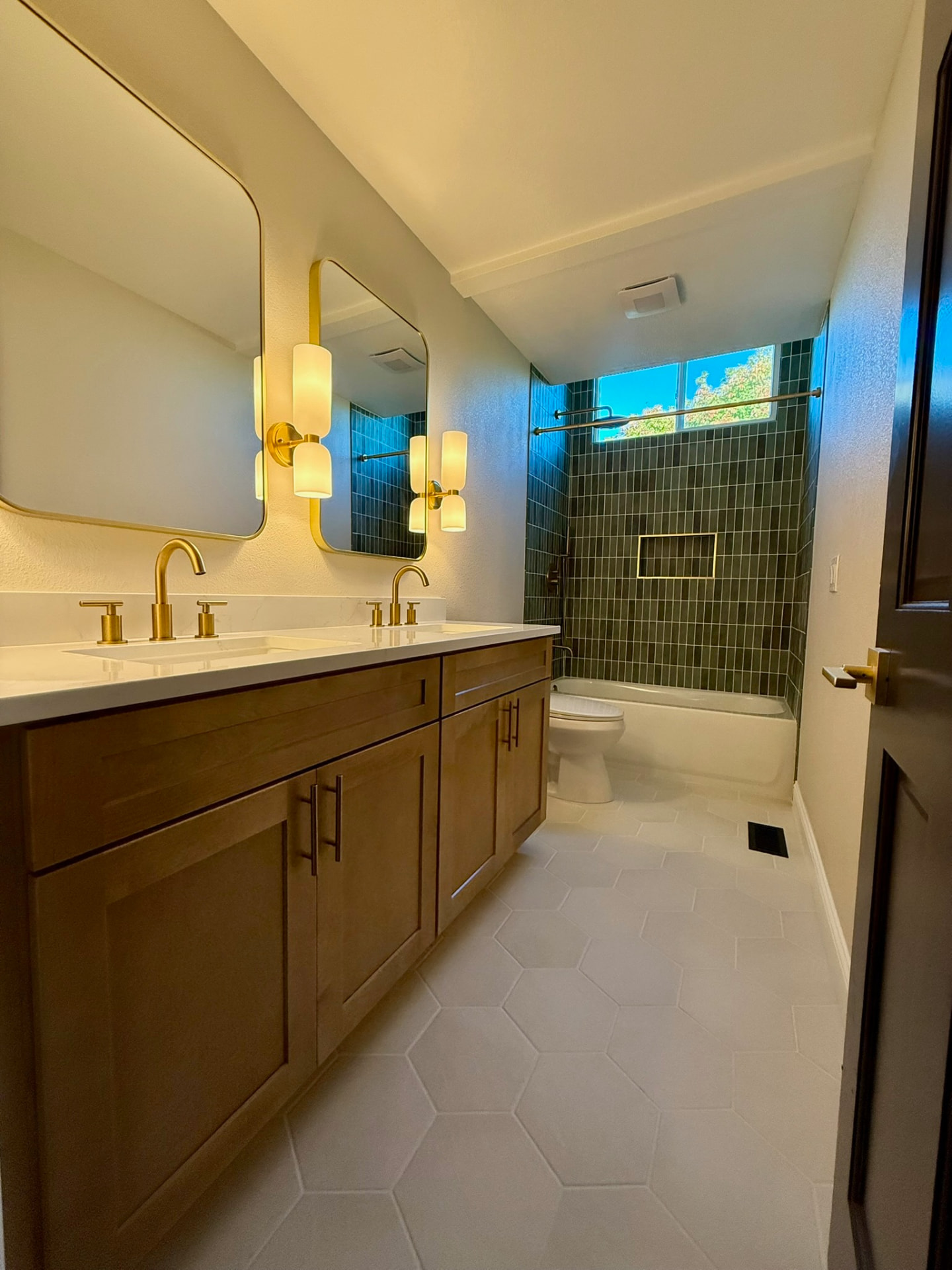 Wide view of remodeled bathroom vanity and tub